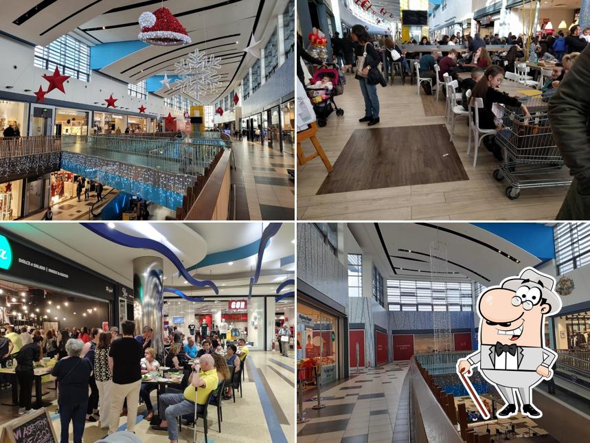 Puoi goderti l'aria fresca da seduto all'esterno di Centro Commerciale Bariblu