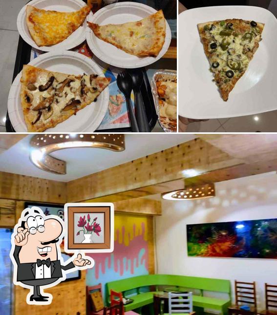 Take a look at the image showing interior and pizza at Fetta Di Pizza