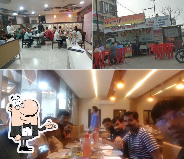 Take a seat at one of the tables at Vrajbhumi Restaurant