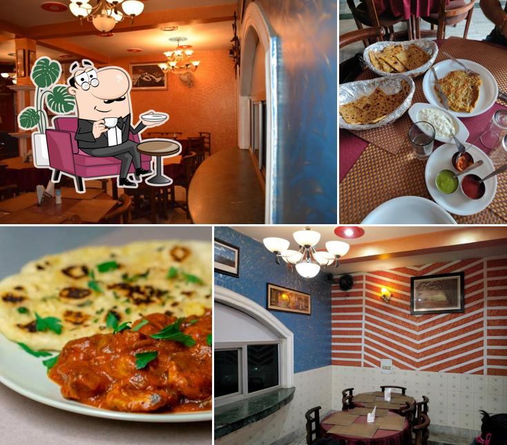 Take a seat at one of the tables at Hari Restaurant And Cafe Hub