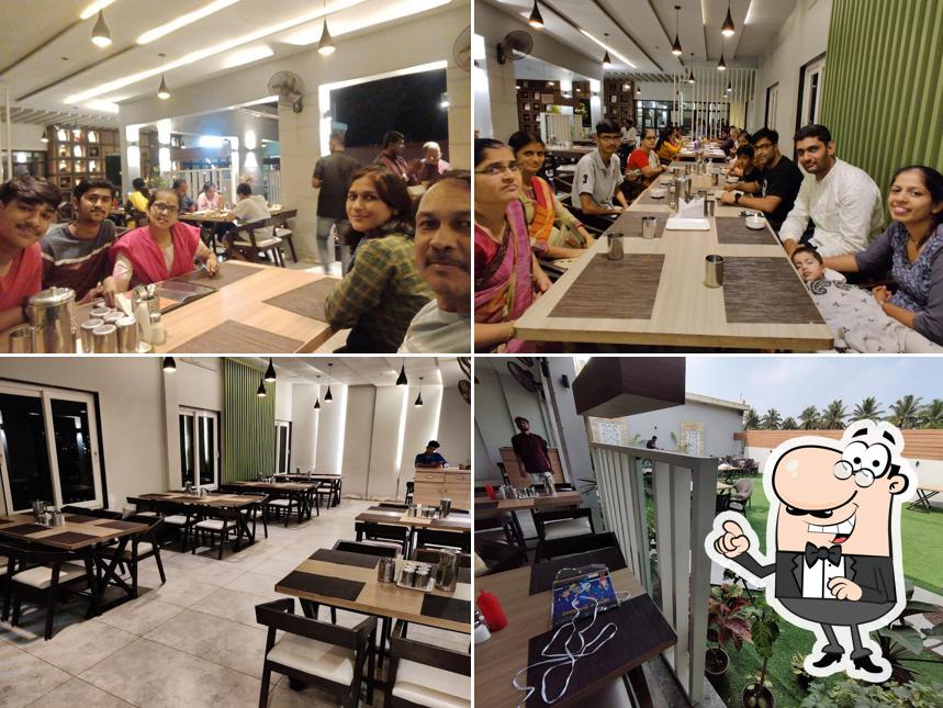 Take a seat at one of the tables at Hotel Orchid Pure Veg (Jaysingpur)