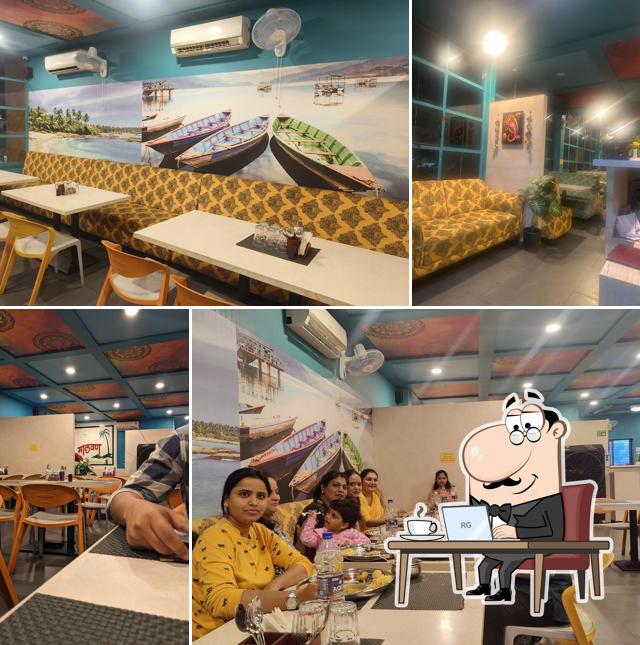 Take a seat at one of the tables at Malvan Seafood Restaurant