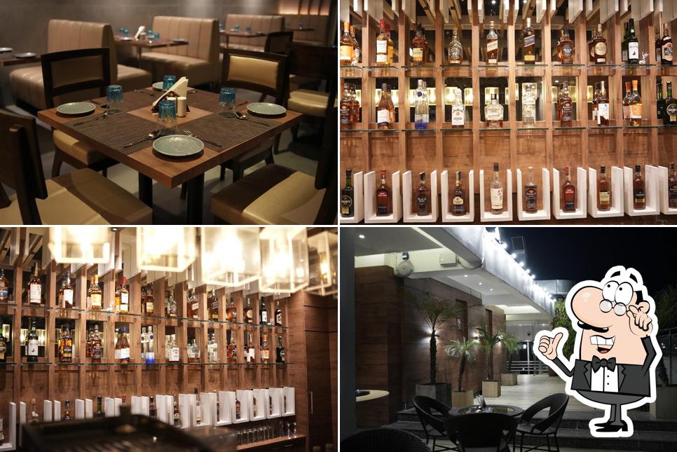 Take a seat at one of the tables at KINGS' CROWN - BEST FAMILY AC BAR & RESTAURANT IN CHINSURAH ROOFTOP SWIMMING POOL INDIAN, CHINESE, CONTINENTAL, TANDOOR