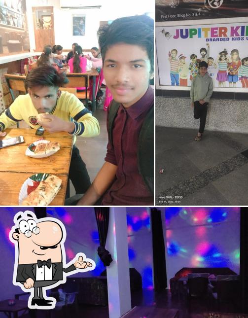 This is the image depicting interior and food at Madrasi Masala Dosa