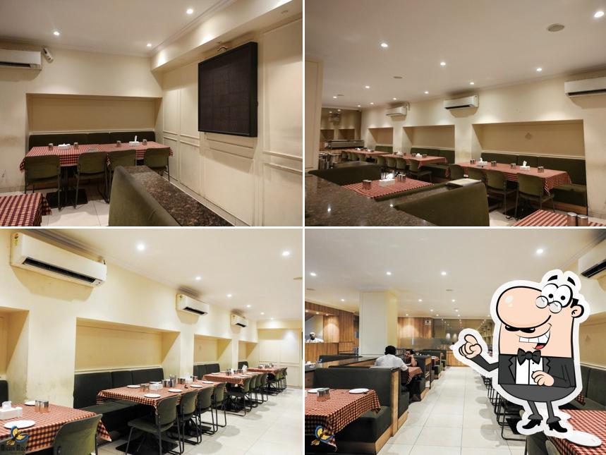 Take a seat at one of the tables at Udupi Tadka Sukhsagar Restaurant