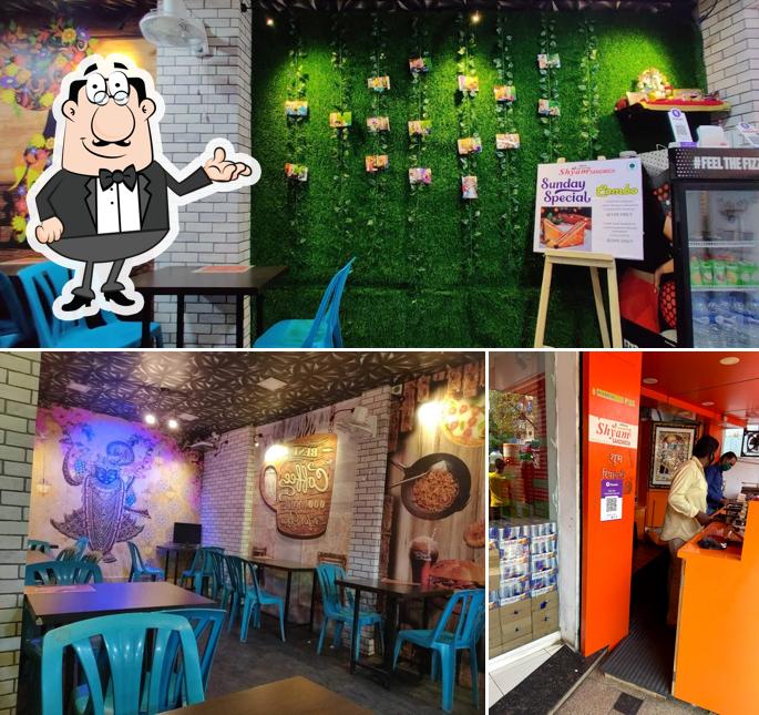 Take a seat at one of the tables at Shyam Sandwich cafe narendra tiwari marg