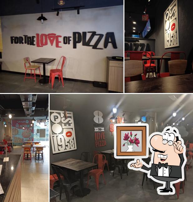 Take a seat at one of the tables at Pizza Hut Genesis Mall, Alwar Take a seat at one of the tables at Pizza Hut Genesis Mall, Alwar