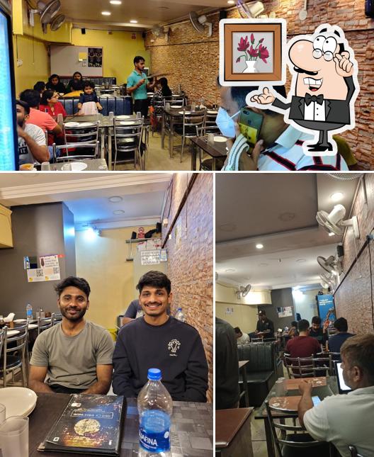 Take a seat at one of the tables at Apnadhaba Taste Of Punjab Pure Veg