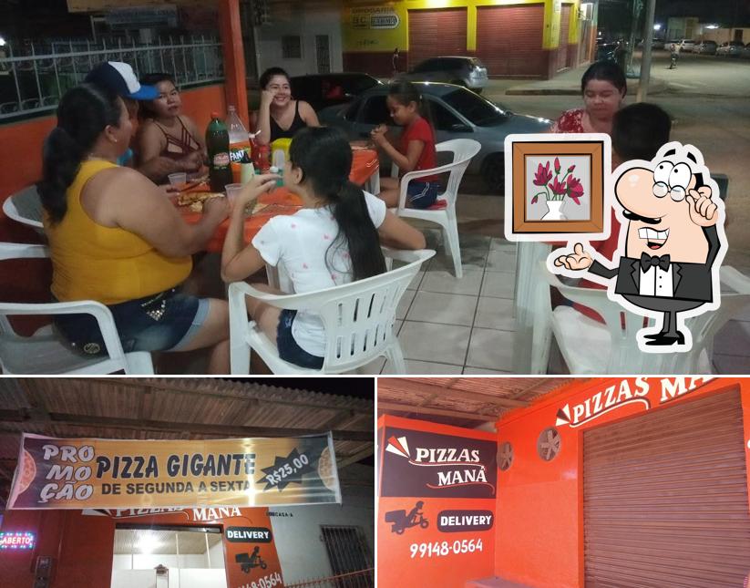 Sente em uma das mesas no Pizzaria Maná