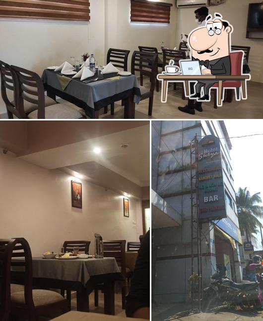 Take a seat at one of the tables at HOTEL SURYA GIRIRANI TOURIST HOME