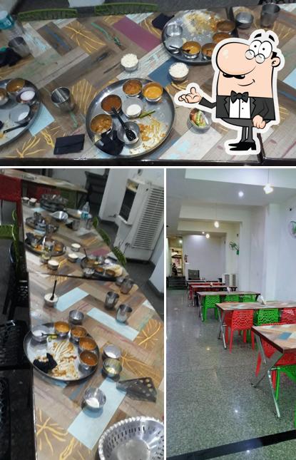 Take a seat at one of the tables at Manuhar Restaurant