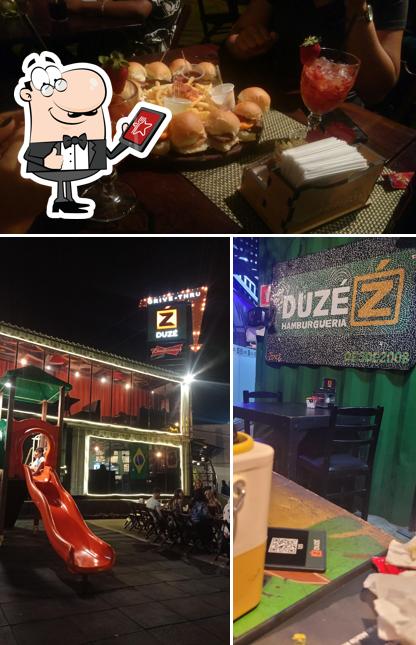 A imagem da exterior e mesa de jantar no Hamburgueria Duzé