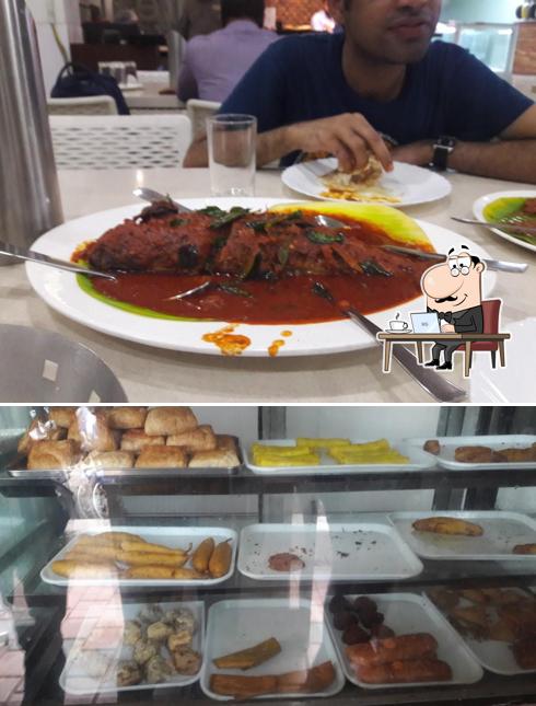 Take a seat at one of the tables at MRA Bakery and Restaurant (Kannur)