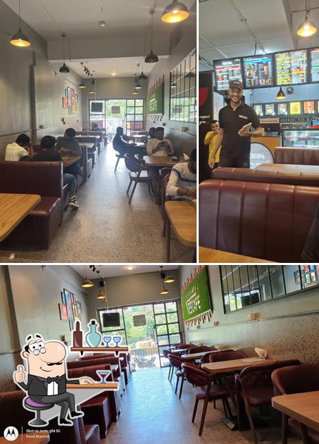 Take a seat at one of the tables at Nescafe - Best Cafe in Rajkot