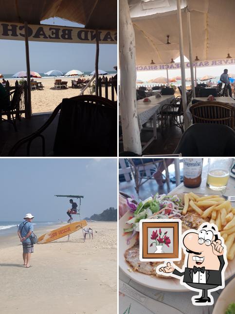 Take a seat at one of the tables at Silver sand beach shack