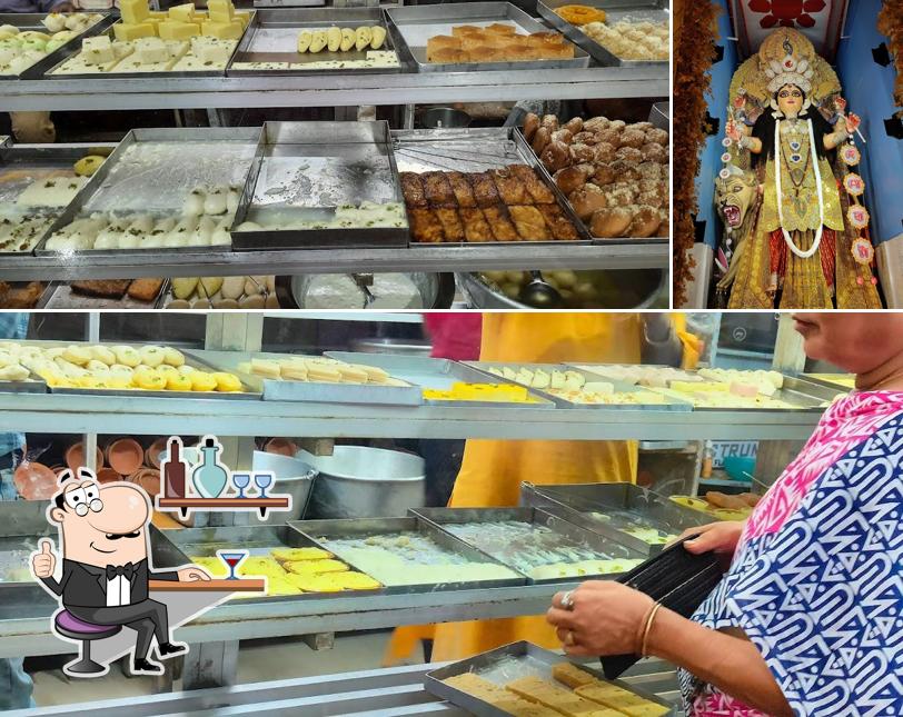 Take a look at the image displaying interior and food at Mrityunjoy Sweets