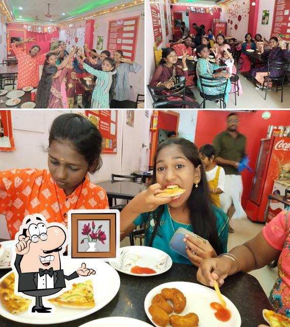 Take a seat at one of the tables at Delicious Pizza