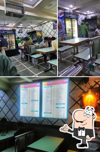 Take a seat at one of the tables at Pushpavihar