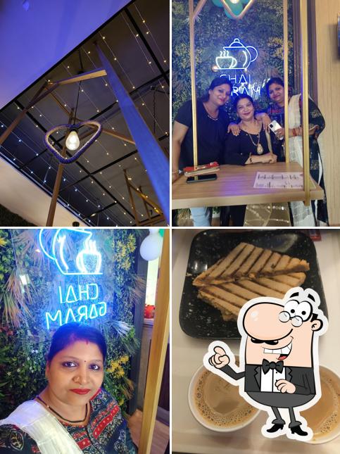 Take a seat at one of the tables at chai garam pocket cafe - rohini