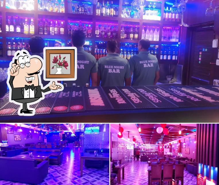 Take a seat at one of the tables at Blue Night Bar& Restaurant