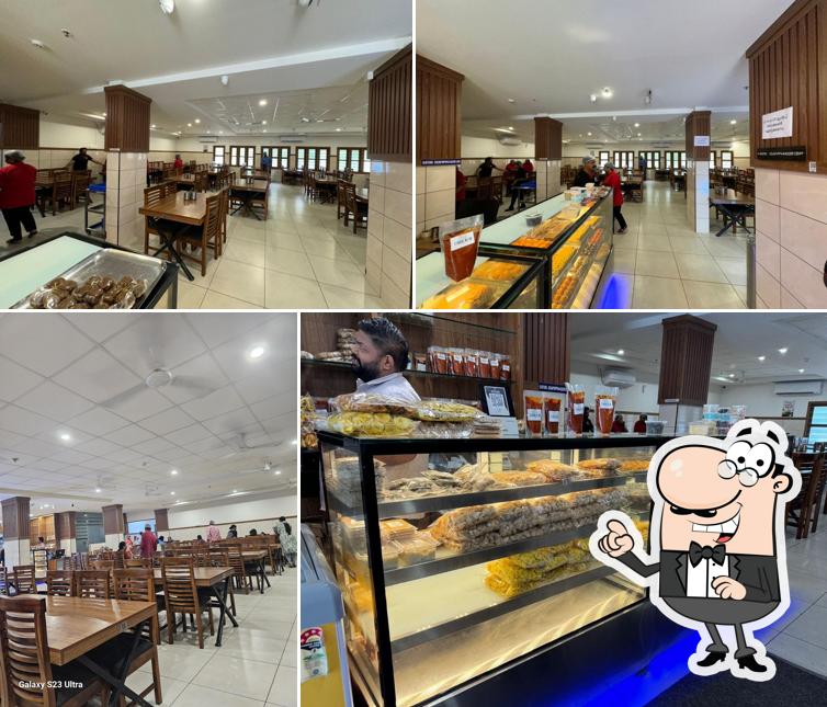 Take a seat at one of the tables at Pazhayidom Ruchi Restaurant