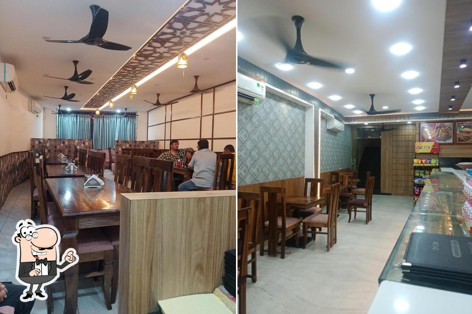 Take a seat at one of the tables at Chandan Shree Restaurant & Sweet