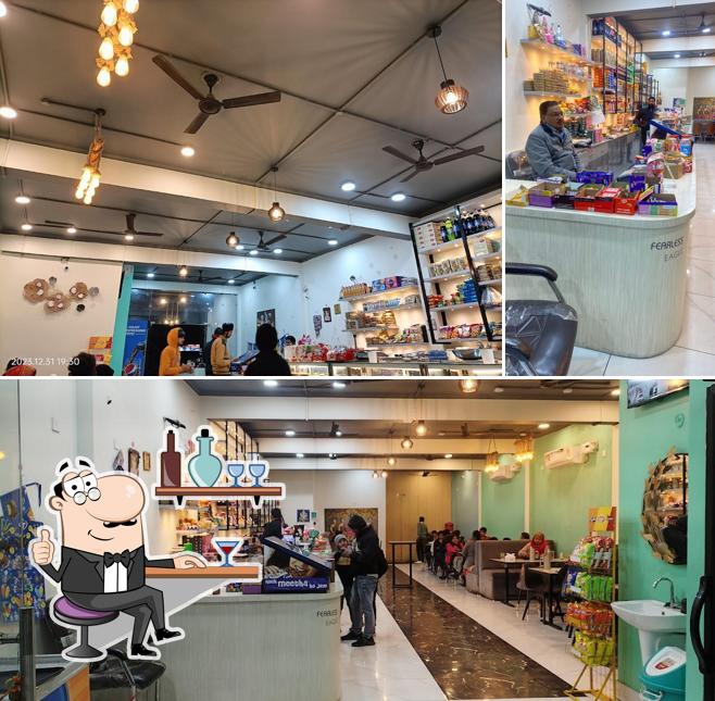 Take a seat at one of the tables at Kavyanshi Agarwal Sweets and Fast Food