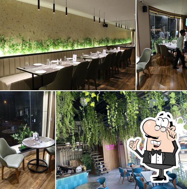 Take a seat at one of the tables at The Green Spice Multicuisine Restaurant & Cafe