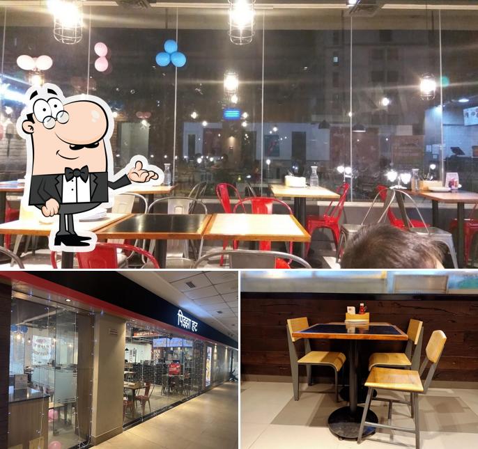 Take a seat at one of the tables at Pizza Hut The Walk, Thane West, Mumbai