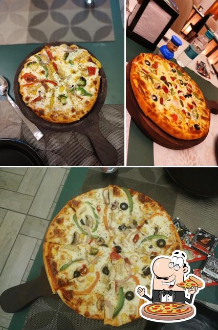 Get pizza at Nikhar's Cafe