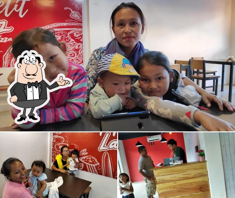 Take a seat at one of the tables at Laziz Pizza