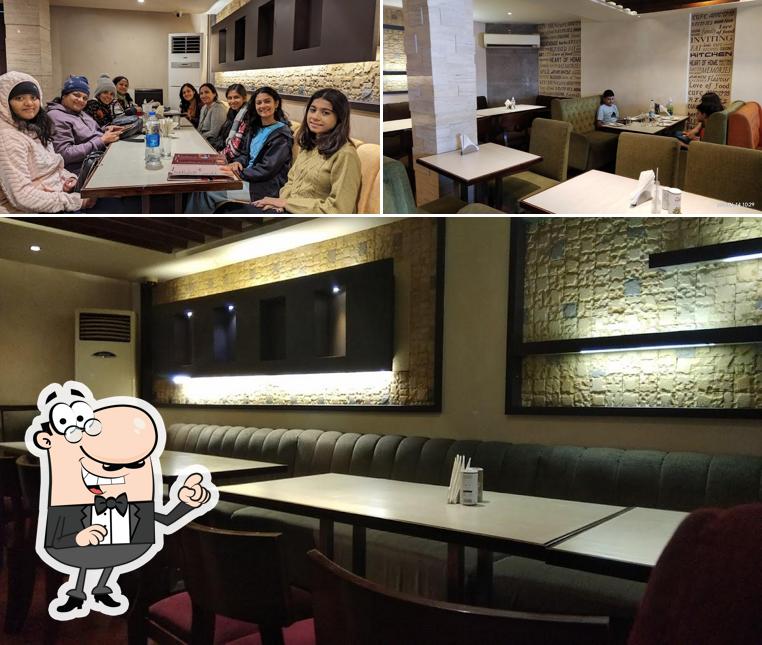 Take a seat at one of the tables at Kwality Restaurant