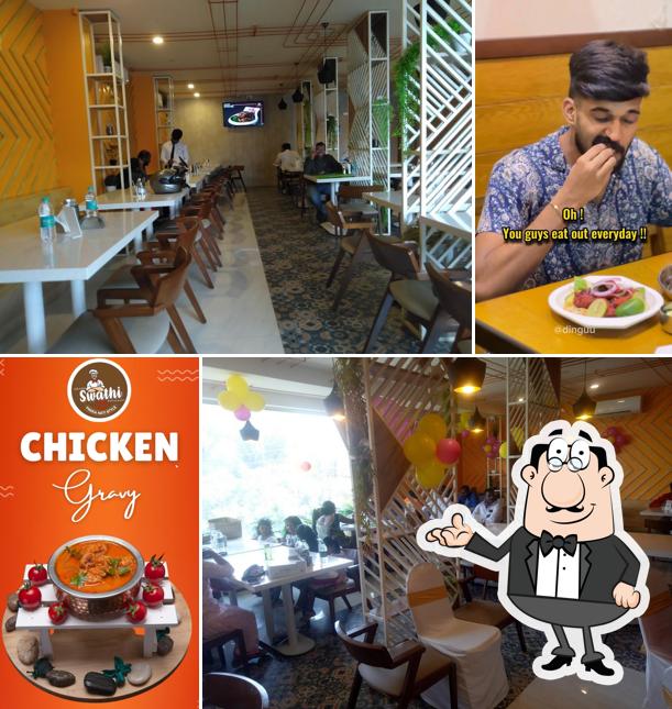 Take a seat at one of the tables at Swathi Restaurant