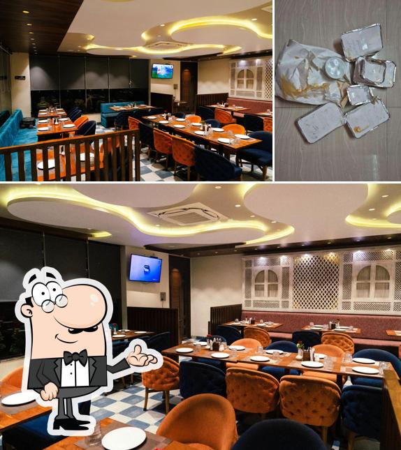 Take a seat at one of the tables at Majhali Fine - Dine Seafood Restaurant
