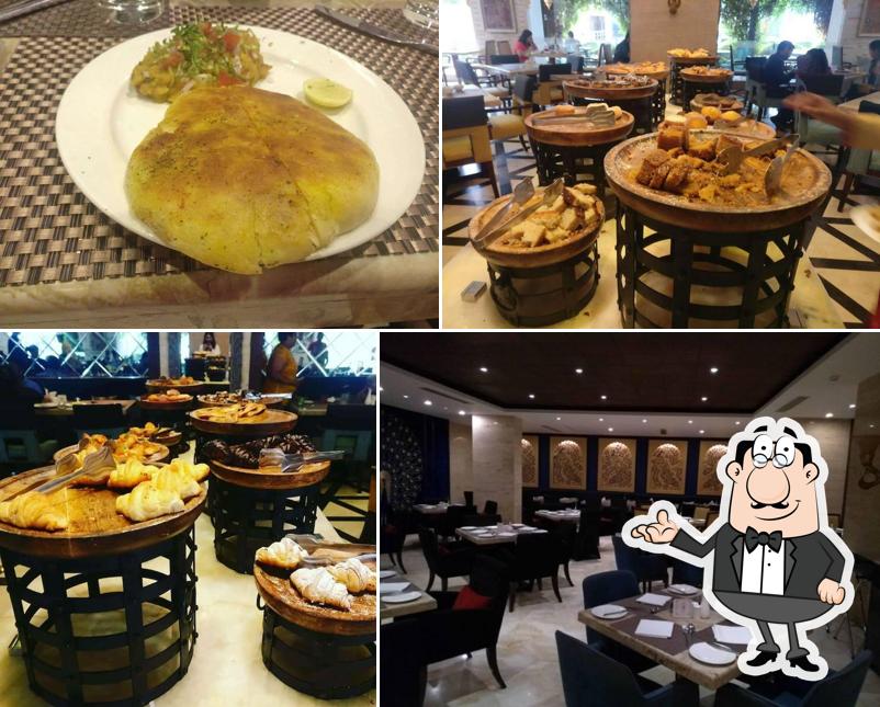 Take a seat at one of the tables at Neel Mahal - Radisson Blu