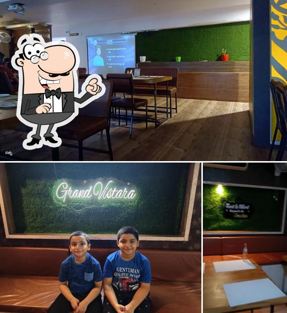 Take a seat at one of the tables at Grand Vistara Restaurant