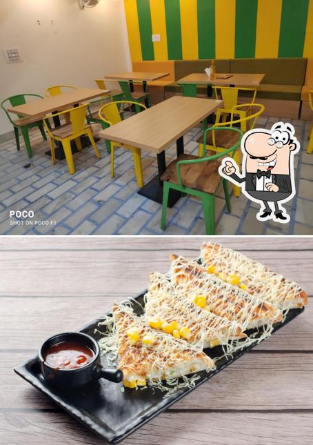 Take a seat at one of the tables at Cheesy Crazy Cafe / Mumma's Bakery & Sweets