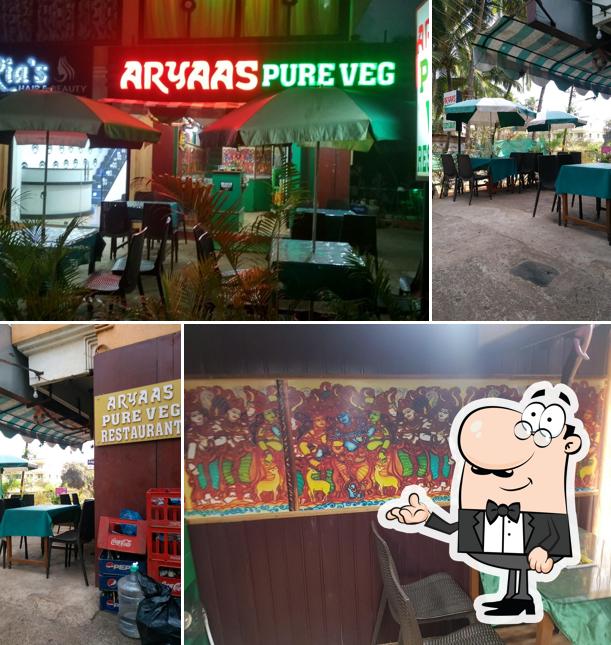 Take a seat at one of the tables at Aryaas Veg Restuarant