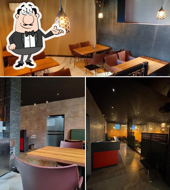 Take a seat at one of the tables at Grandeur Multi Cuisine Restaurant