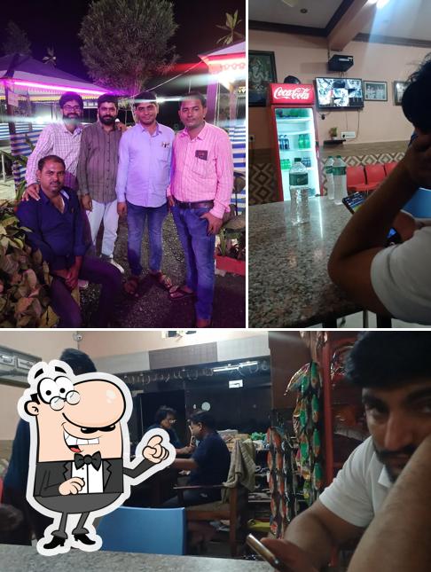 Take a seat at one of the tables at Shri Shakti Restaurant And Hotel