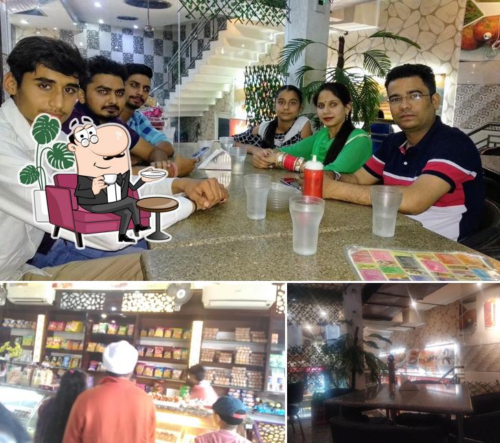 Take a seat at one of the tables at J S Bikaner Sweets
