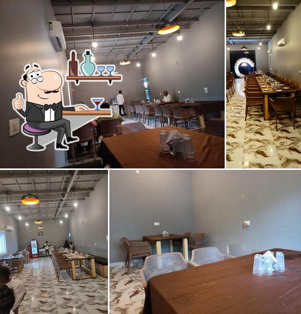 Take a seat at one of the tables at ROOTS A/C party hall & Restaurant