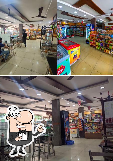 Take a seat at one of the tables at FAMOUS BAKERY MOOZHIKKAL