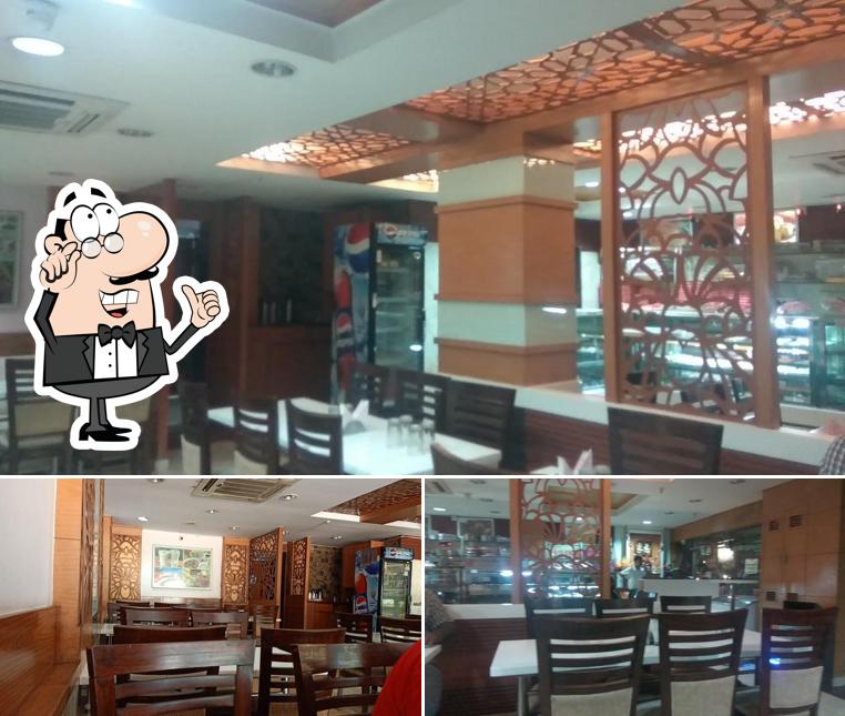 Take a seat at one of the tables at Puja Mithai And Rasoi