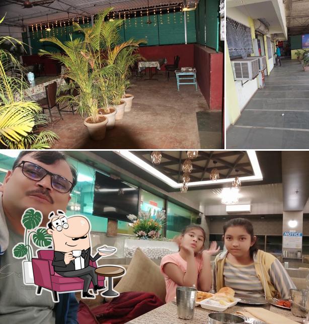 Take a seat at one of the tables at Hotel Chakradhari Bar and Family Restaurants