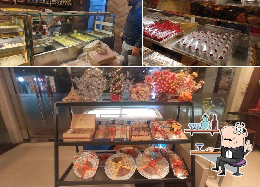 Take a seat at one of the tables at Navrang Sweets & Fast Food