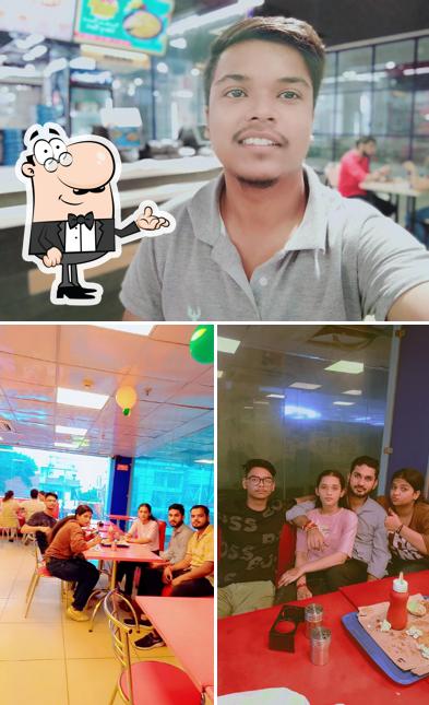 Take a seat at one of the tables at Domino's Pizza Gandhi Park, Aligarh