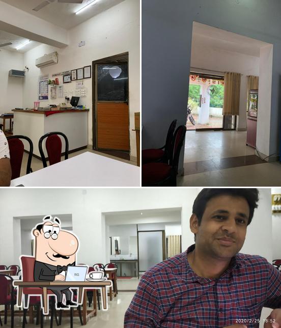 Take a seat at one of the tables at Indian Coffee House And Restaurant