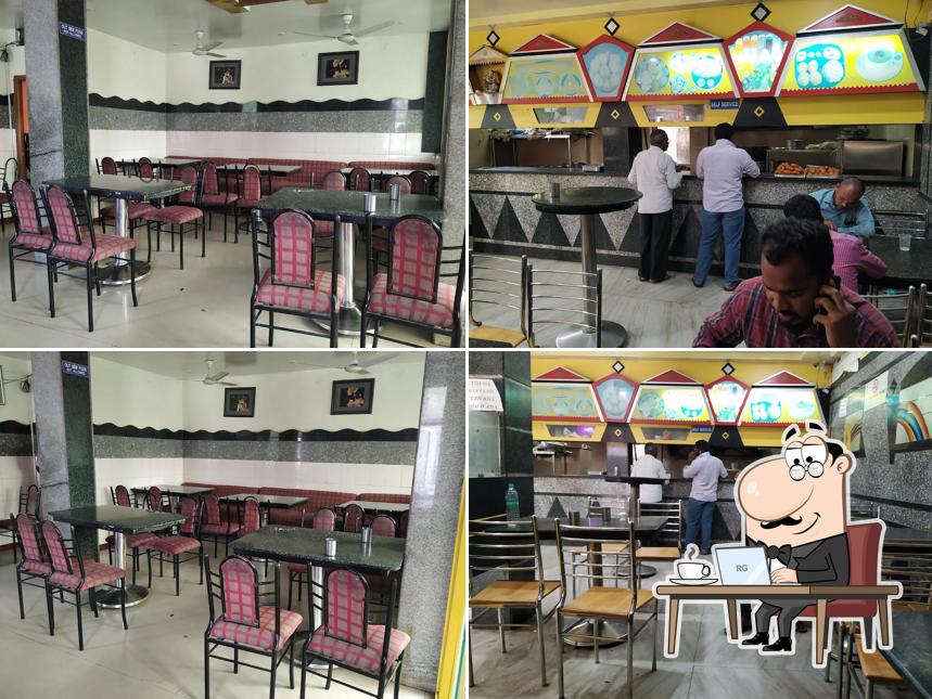 Take a seat at one of the tables at Sri Raghavendra udipi pure veg