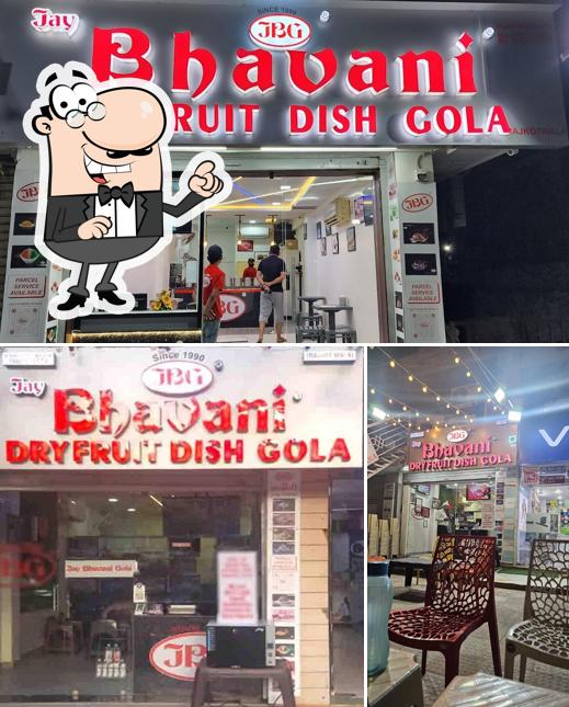 Take a seat at one of the tables at Jay bhavani dryfruit dish gola